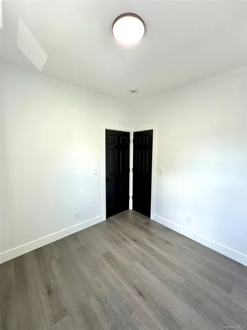 an empty room with wooden floor