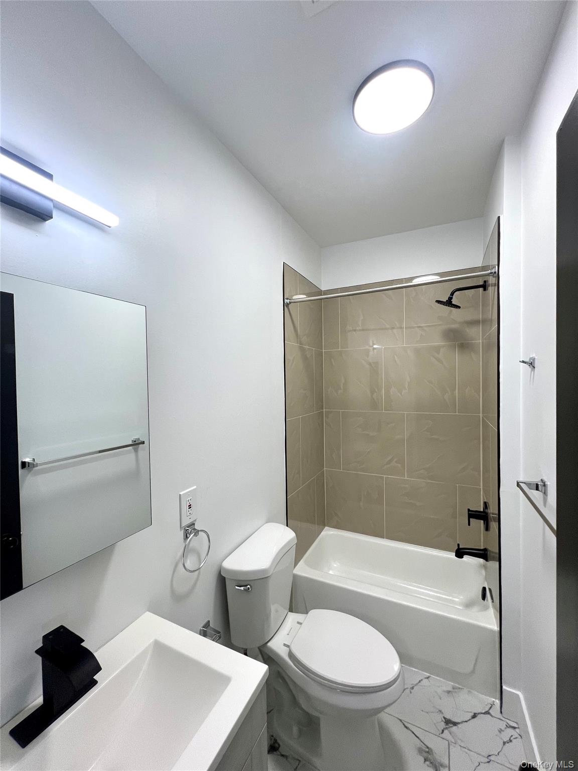 79 Orchard Street, Unit 2 Yonkers, NY 10703 - Photo 21 of 26 a bathroom with a toilet a sink and a bathtub