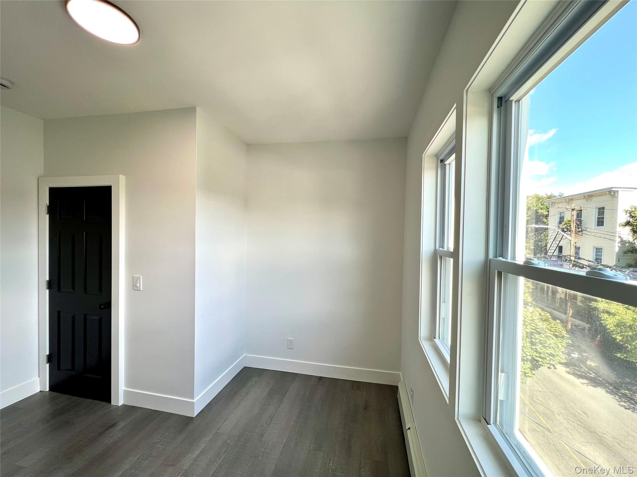 79 Orchard Street, Unit 2 Yonkers, NY 10703 - Photo 22 of 26 a view of a room with wooden floor and windows