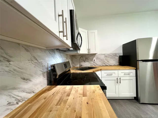 a kitchen with a refrigerator and a stove