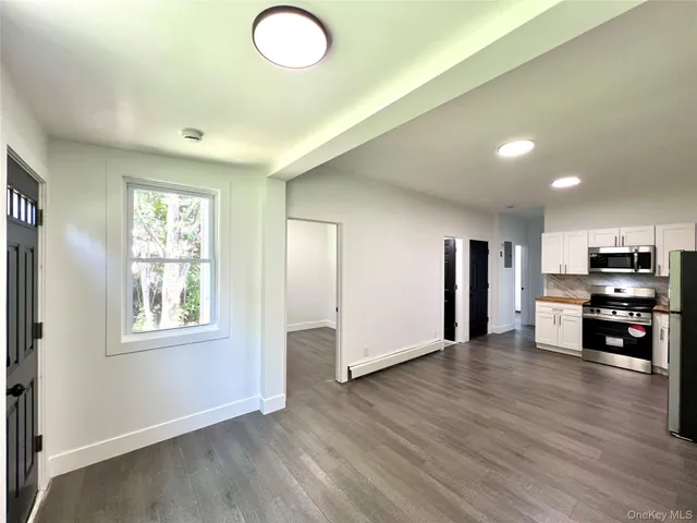 a view of a livingroom with furniture and wooden floor