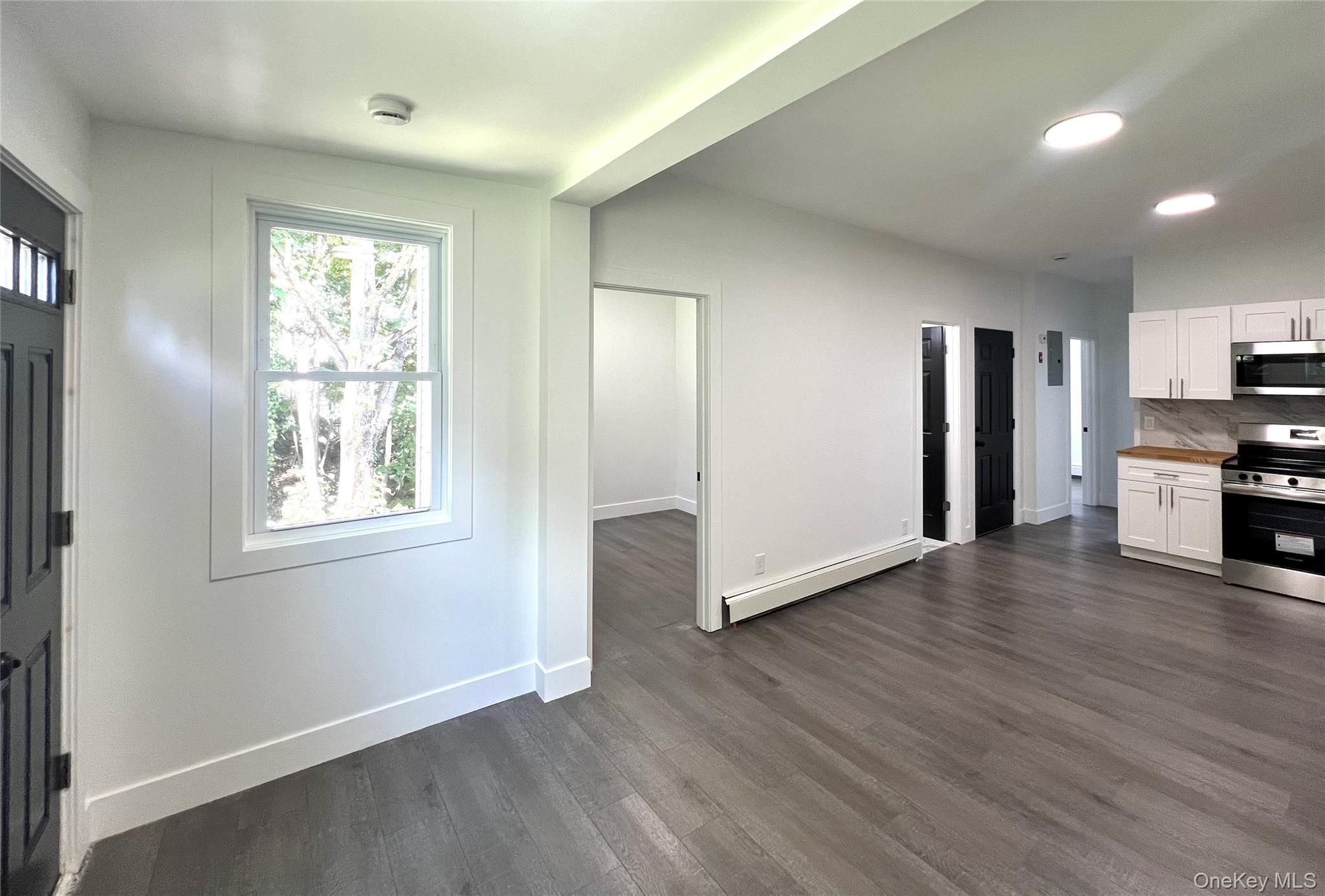 79 Orchard Street, Unit 2 Yonkers, NY 10703 - Photo 8 of 26 a view of empty room with wooden floor and window