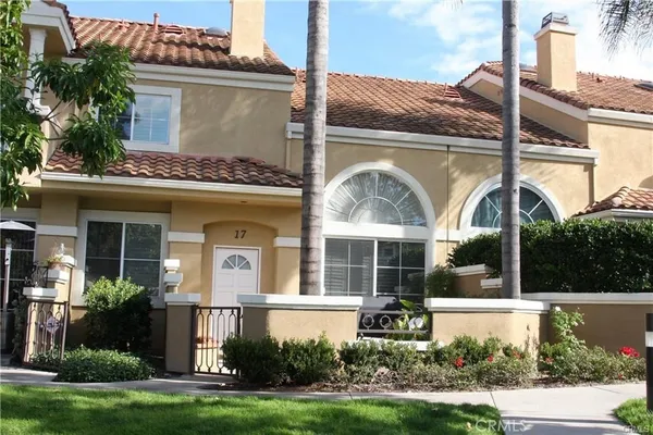 a front view of a house with a garden and plants