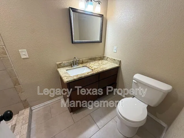 a bathroom with a sink a toilet and mirror