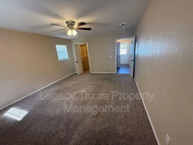 a view of a livingroom with a ceiling fan and window