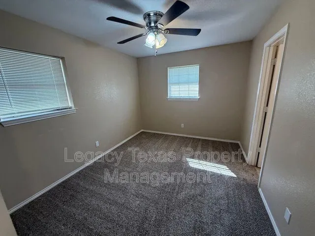 a view of a livingroom with a ceiling fan and window
