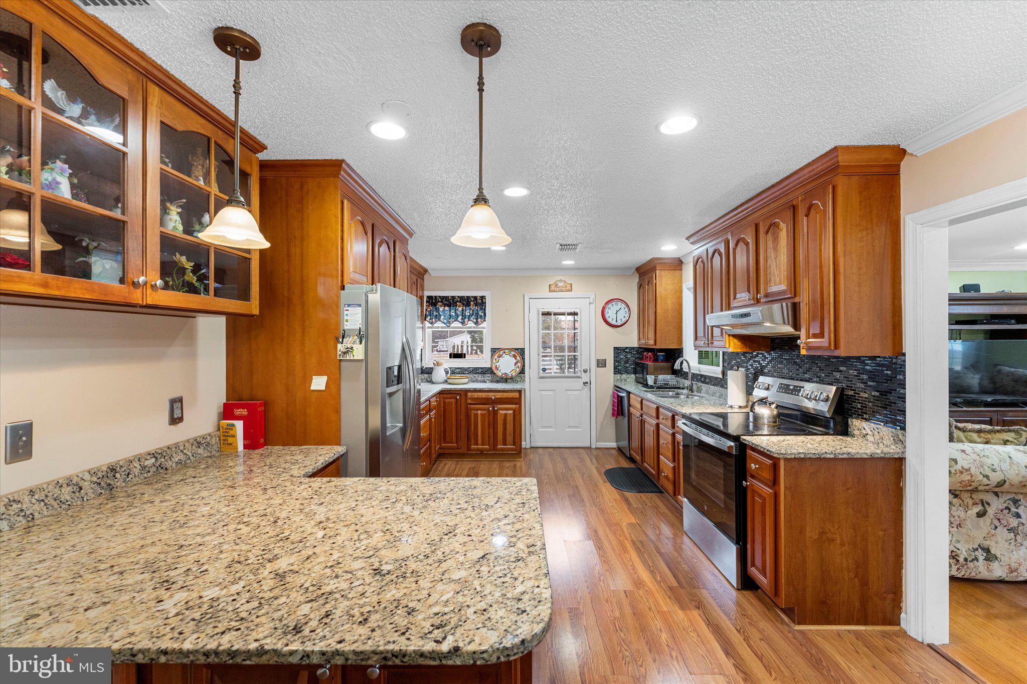 14917 Compton Road Centreville, VA 20121 - Photo 6 of 42 a kitchen with stainless steel appliances granite countertop sink stove top oven and refrigerator