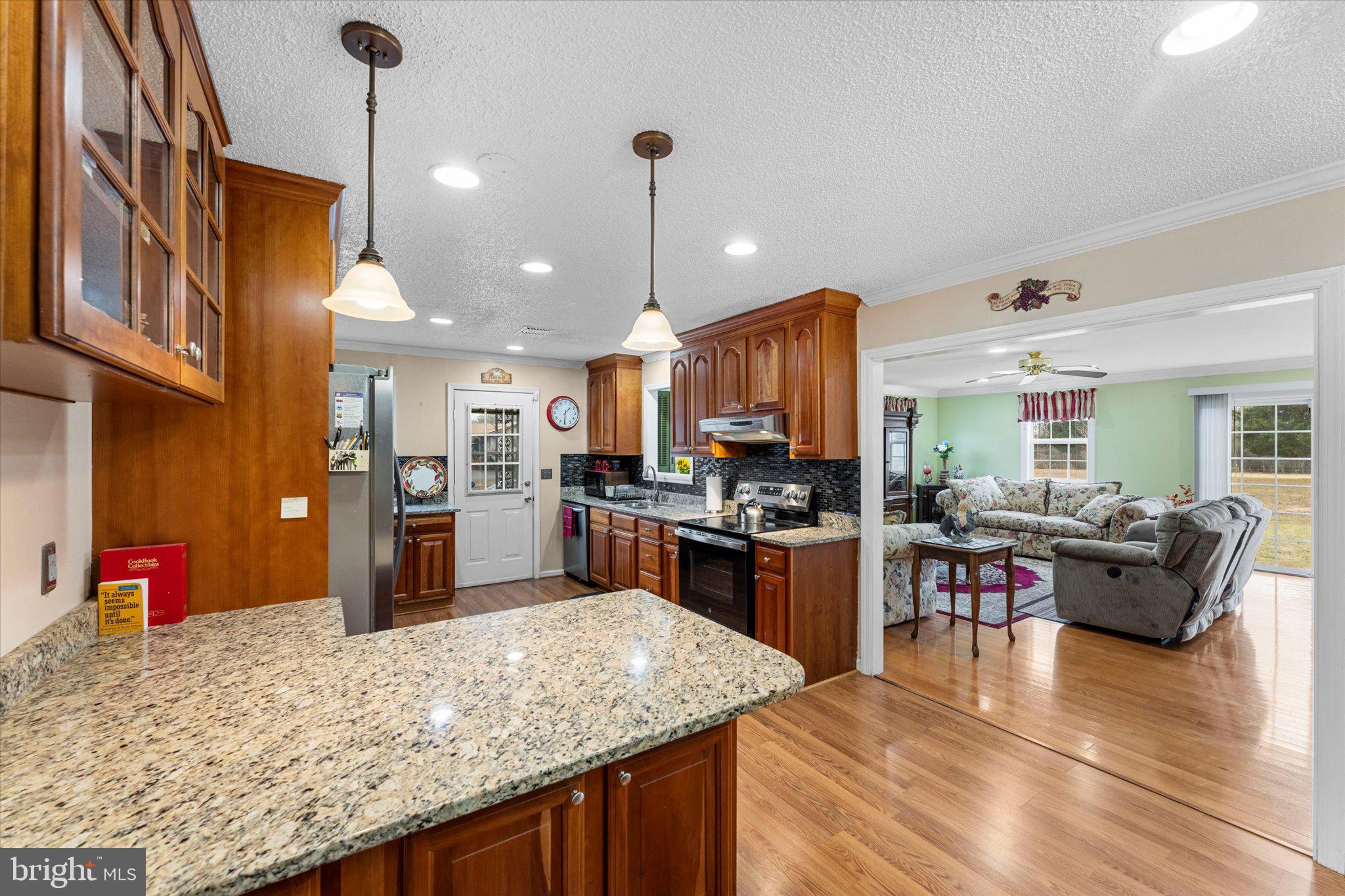 14917 Compton Road Centreville, VA 20121 - Photo 7 of 42 a kitchen with stainless steel appliances granite countertop sink stove top oven and refrigerator