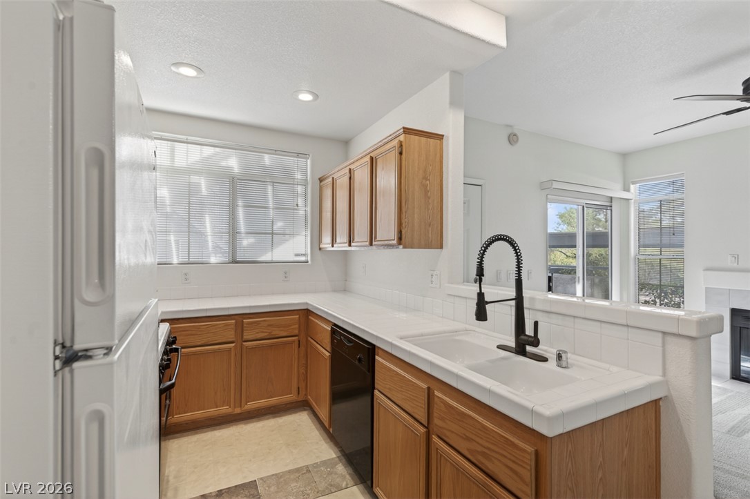 2201 Ramsgate Drive, Unit 1011 Henderson, NV 89074 - Photo 13 of 40 A functional kitchen boasts ample cabinetry and essential appliances for everyday living.