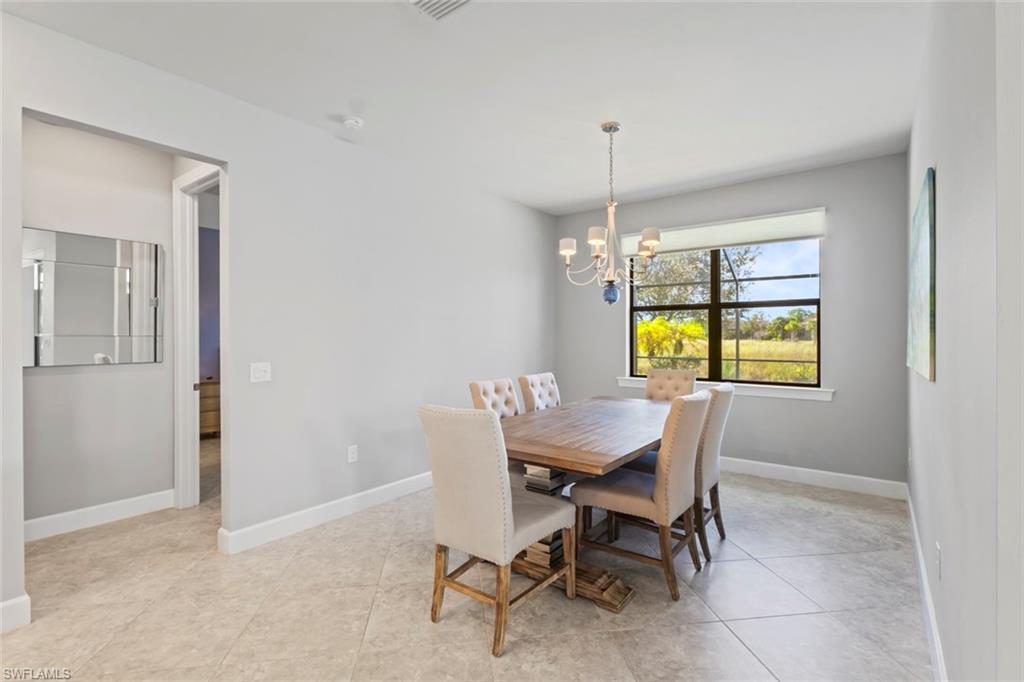 19902 Beverly Park Road Estero, FL 33928 - Photo 11 of 47 Dining space featuring a chandelier and light tile patterned floors