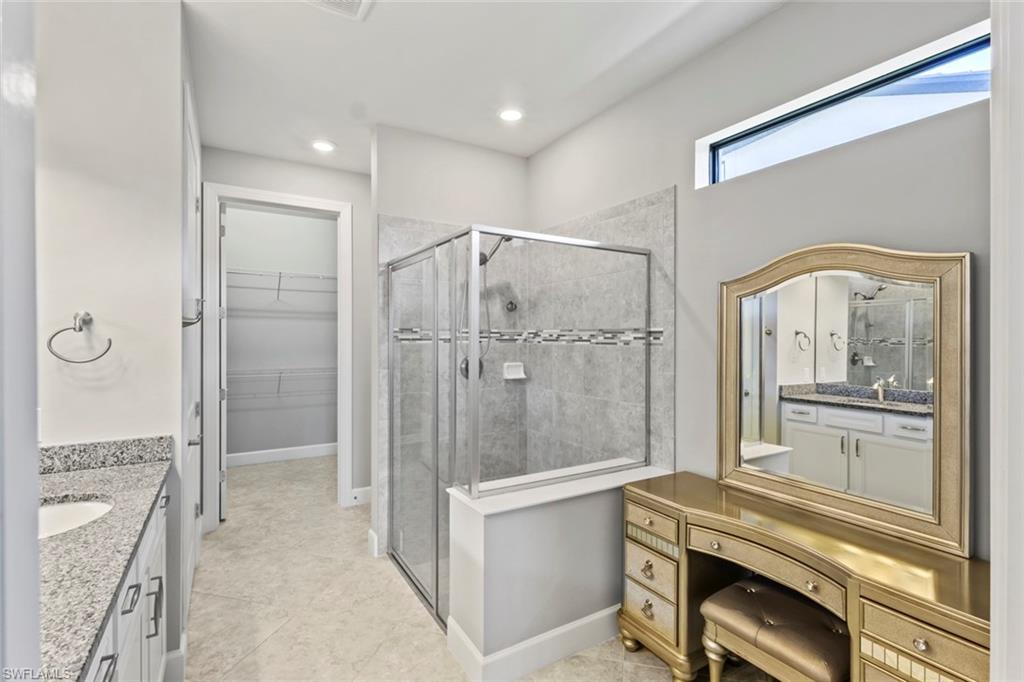 19902 Beverly Park Road Estero, FL 33928 - Photo 15 of 47 Bathroom featuring vanity, a walk in closet, a shower stall, and recessed lighting