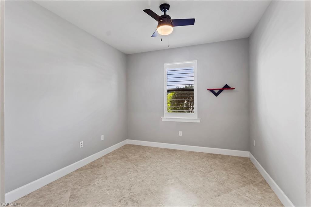 19902 Beverly Park Road Estero, FL 33928 - Photo 18 of 47 Spare room featuring a ceiling fan and baseboards