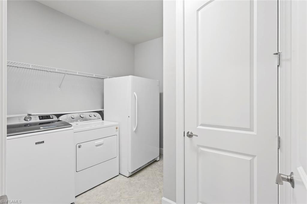 19902 Beverly Park Road Estero, FL 33928 - Photo 19 of 47 Washroom featuring washer and clothes dryer and light tile patterned flooring