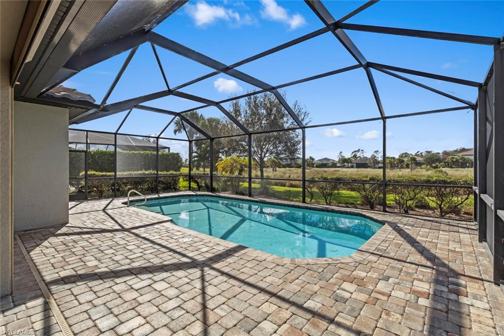 19902 Beverly Park Road Estero, FL 33928 - Photo 21 of 47 Outdoor pool featuring a sunroom, a patio, and glass enclosure