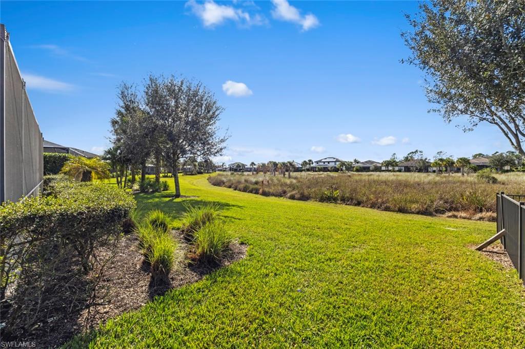 19902 Beverly Park Road Estero, FL 33928 - Photo 24 of 47 View of green lawn with glass enclosure