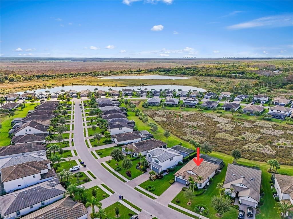 19902 Beverly Park Road Estero, FL 33928 - Photo 27 of 47 Aerial view of property and surrounding area featuring nearby suburban area and a large body of water