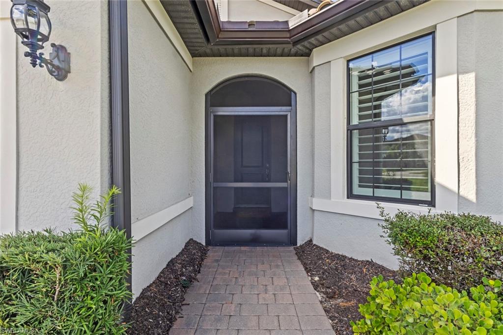 19902 Beverly Park Road Estero, FL 33928 - Photo 4 of 47 Entrance to property featuring stucco siding