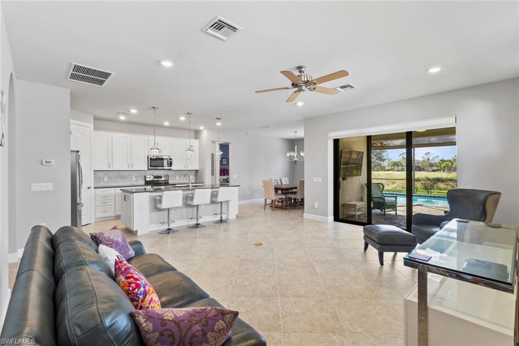 19902 Beverly Park Road Estero, FL 33928 - Photo 6 of 47 Living area with a ceiling fan, recessed lighting, a chandelier, and light tile patterned floors
