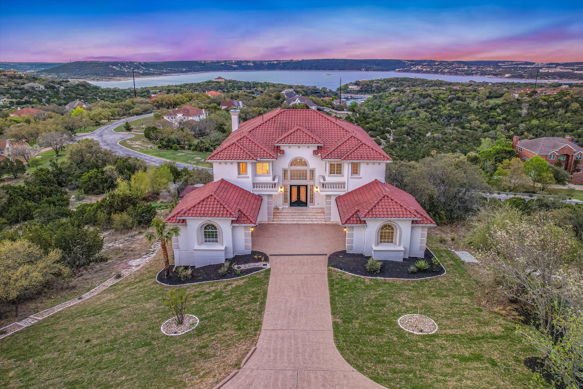 4319 Rum Runner Road Austin, TX 78734 - Photo 1 of 40 Mediterranean / spanish-style home with stucco siding, a lawn, a tile roof, and a chimney