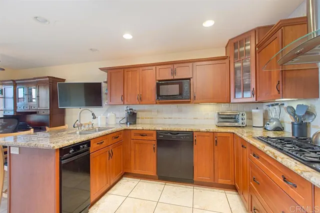 a kitchen with stainless steel appliances granite countertop a sink stove and cabinets