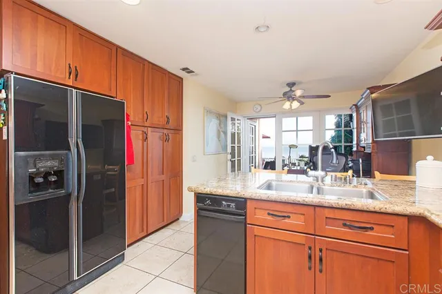 a kitchen with stainless steel appliances granite countertop a refrigerator and a sink