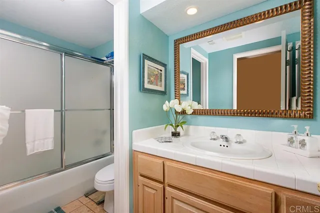 a bathroom with a sink toilet double vanity and shower