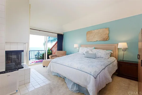 a bedroom with a bed and a fireplace