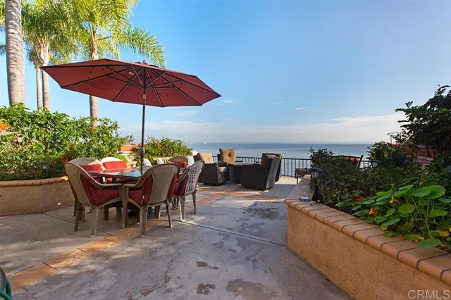 a view of a tables and chairs under an umbrella in patio