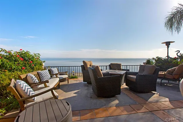 a roof deck with a table and chairs