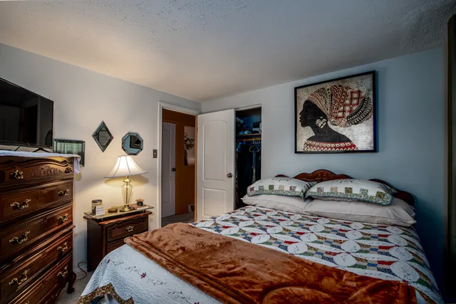 a bedroom with a bed and dresser