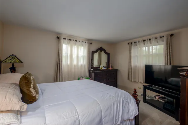 a bedroom with a bed and a television in it