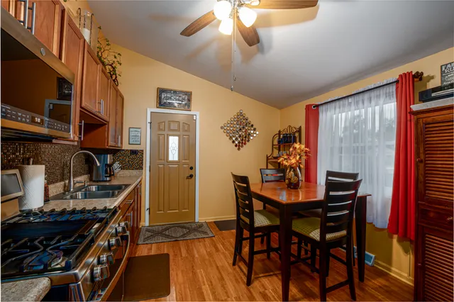 a view of a dining room with furniture and chandelier