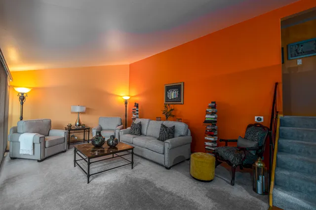 a living room with furniture and a lamp