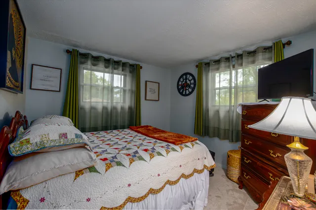 a bedroom with a bed and flat screen tv