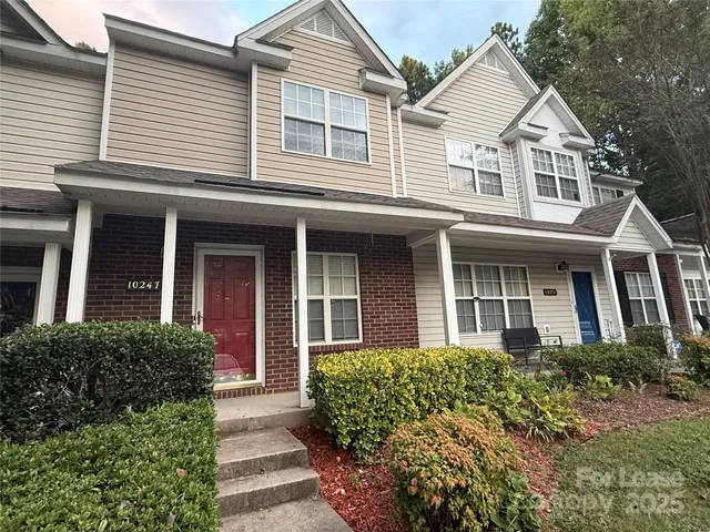 front view of a house next to a yard