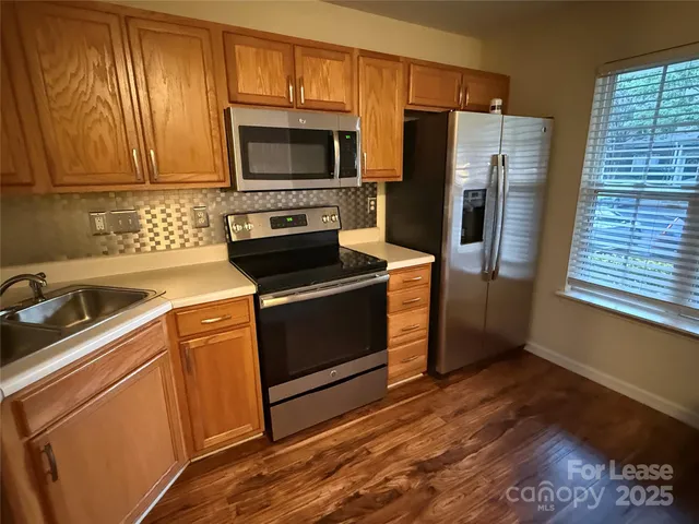 a kitchen with a stove microwave and refrigerator