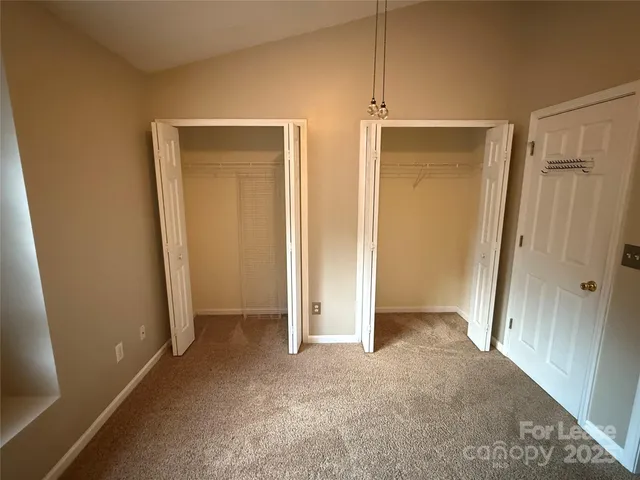 a view of an empty room with closet area