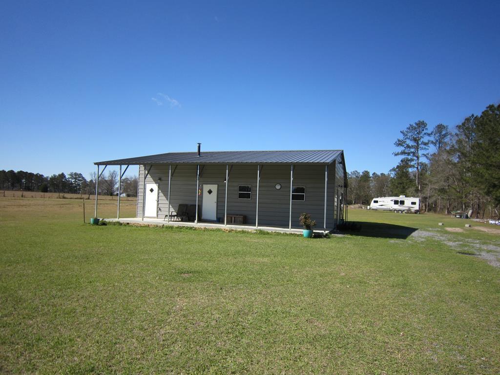 734 Avera Road Roberta, GA 31078 - Photo 3 of 17 a view of a house with a garden and yard