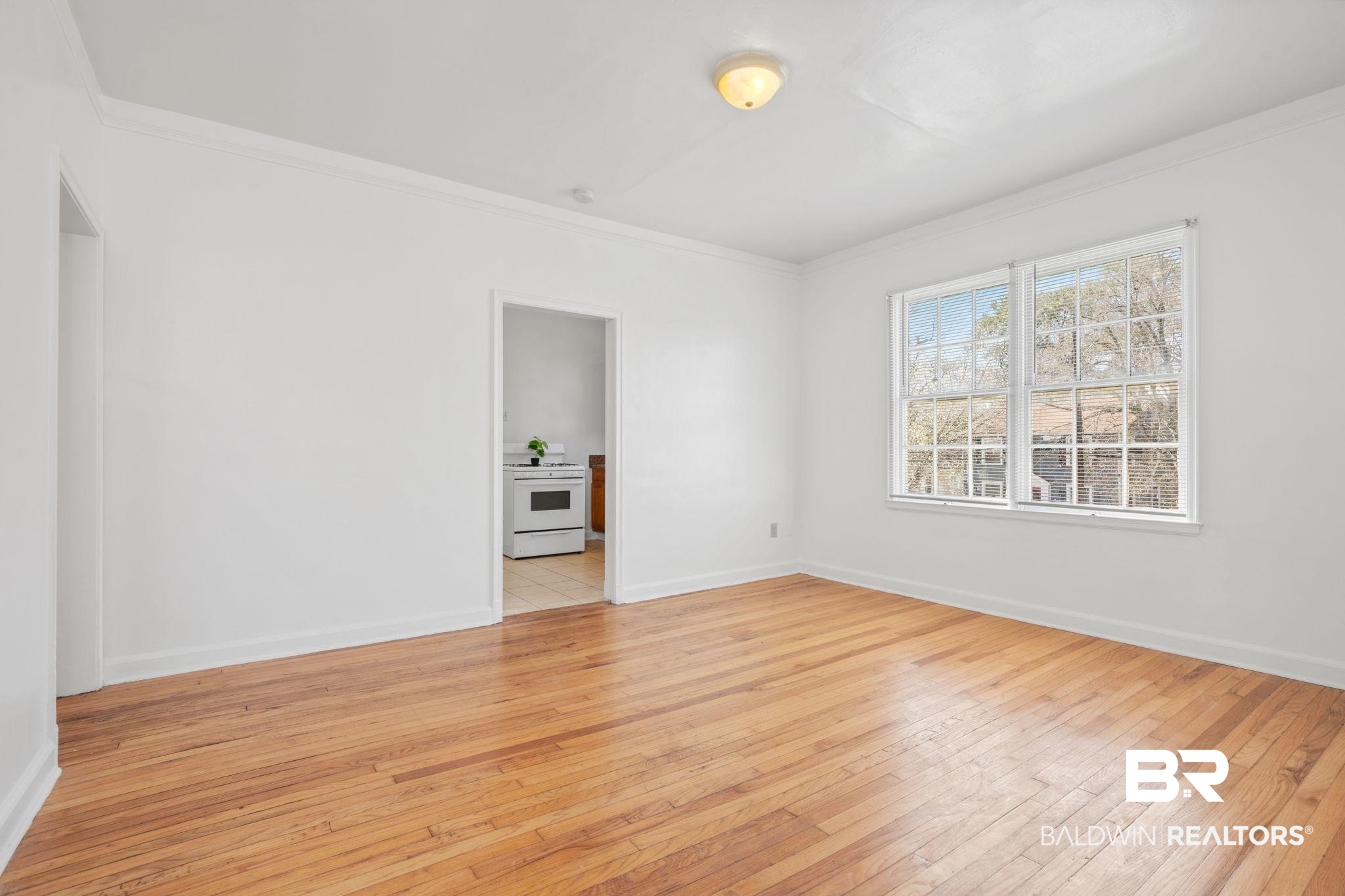 1707 Church Street Mobile, AL 36604 - Photo 28 of 43 Spare room featuring crown molding, baseboards, and light wood-type flooring