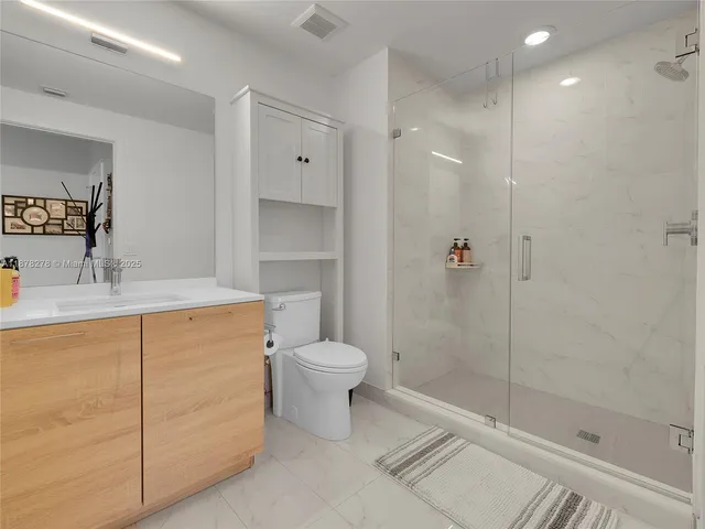 a bathroom with a shower toilet and sink