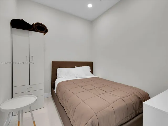 a bedroom with a bed and a chair