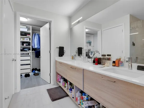 a bathroom with a sink double vanity and a shower