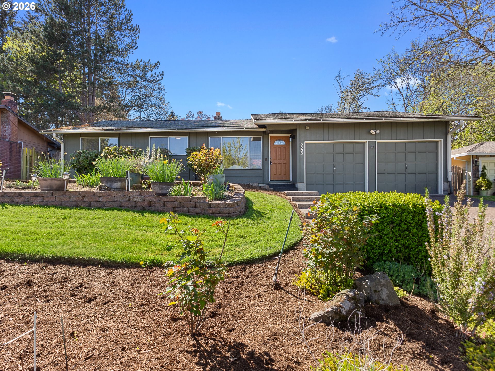 5535 Southwest 142nd Avenue Beaverton, OR 97005 - Photo 3 of 45 a front view of a house with a yard and garage