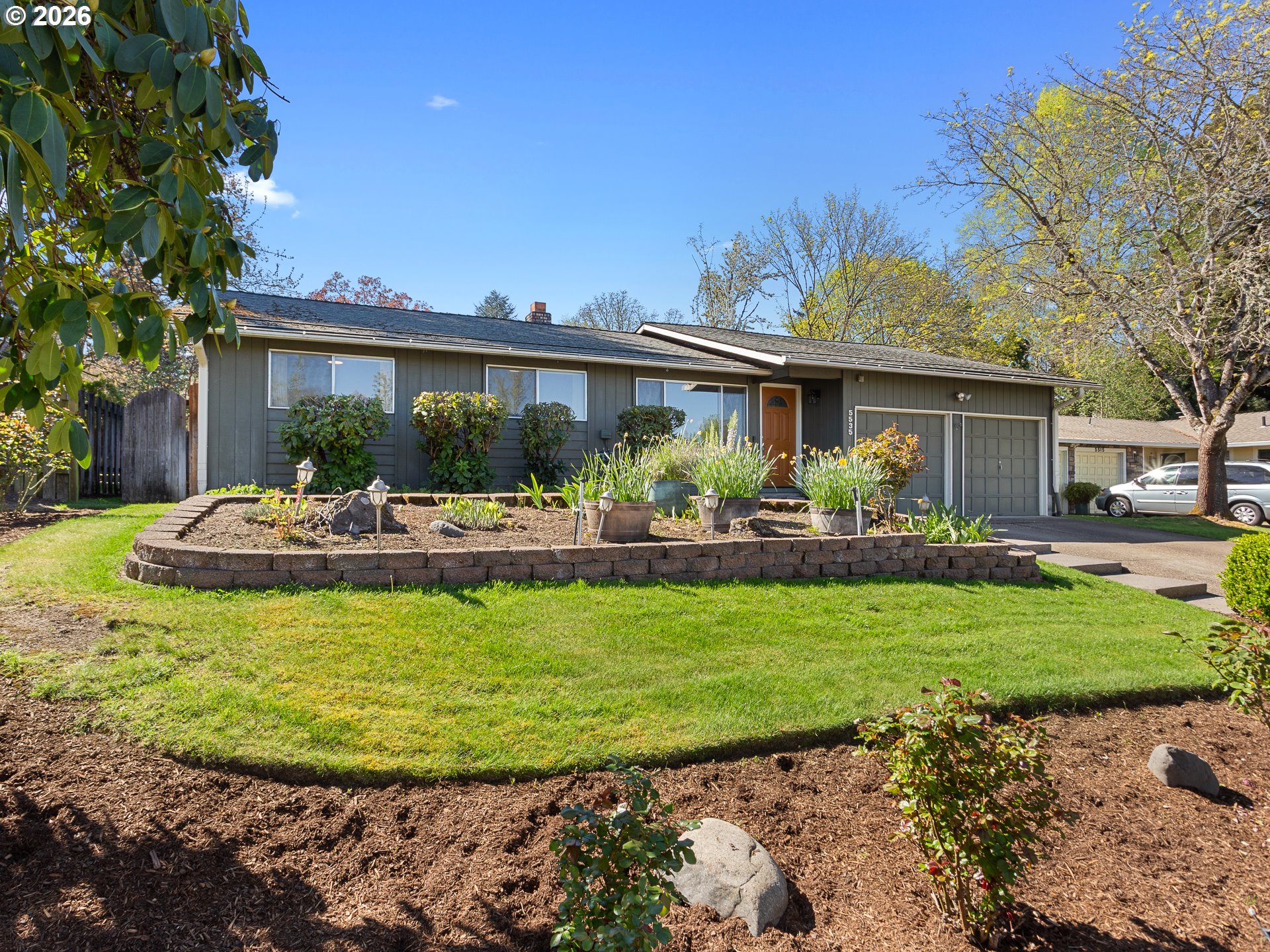 5535 Southwest 142nd Avenue Beaverton, OR 97005 - Photo 4 of 45 a view of a house with a garden and plants