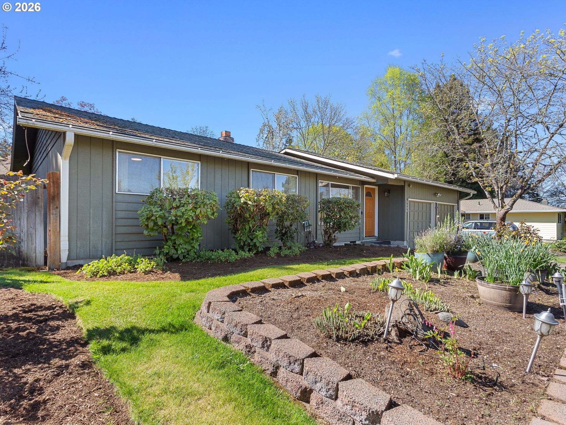 5535 Southwest 142nd Avenue Beaverton, OR 97005 - Photo 5 of 45 a front view of a house with a yard and potted plants