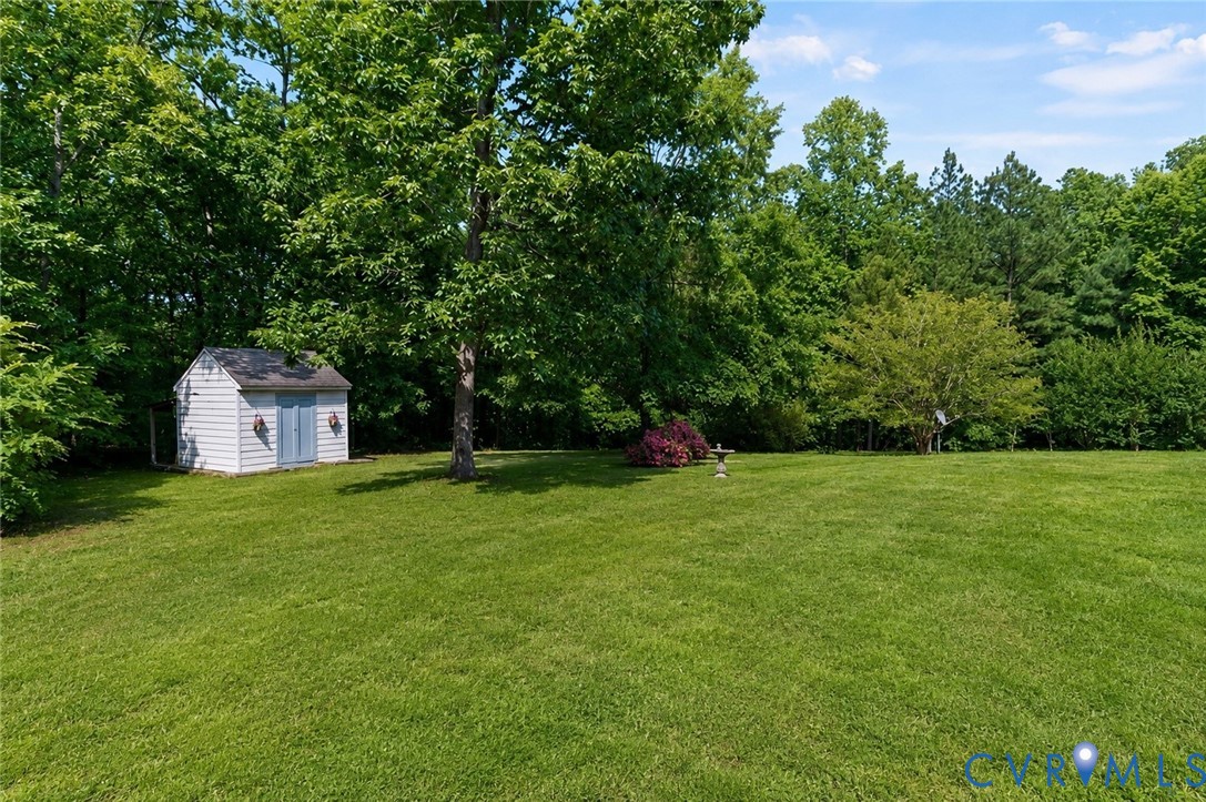 20010 River Road Chesterfield, VA 23838 - Photo 32 of 36 a front view of a house with a yard and trees