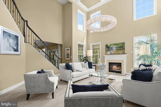 a living room with patio furniture and a potted plant