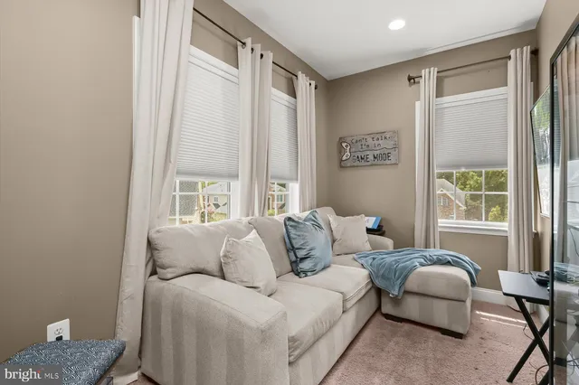 a living room with furniture and view of kitchen