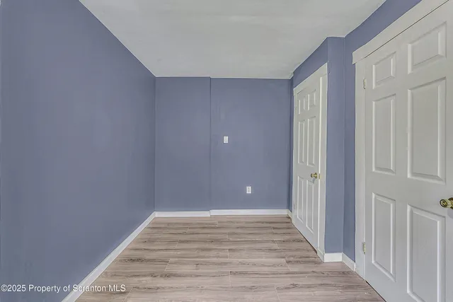 a yellow and red house with a yard