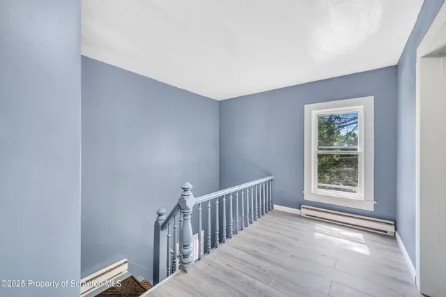 a view of a big house with a big yard and potted plants